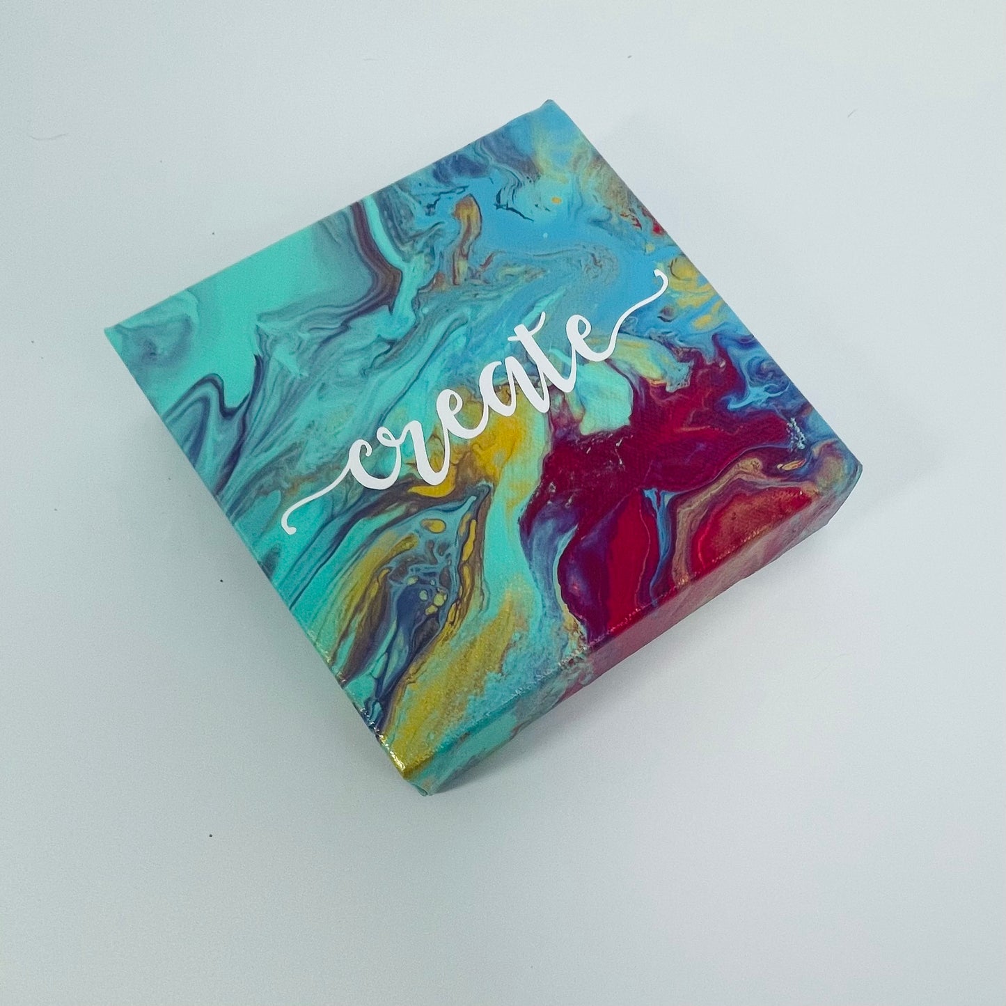 The Monet Create Block. A colorful hand painted painting that says 'create'