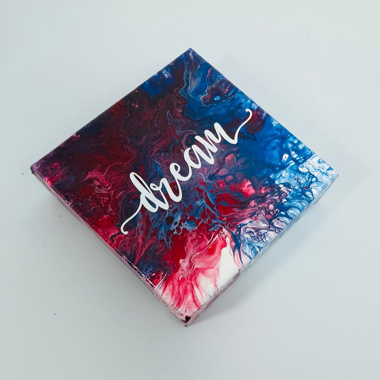 The Intention Dream Block. A colorful hand painted painting that says 'Dream'