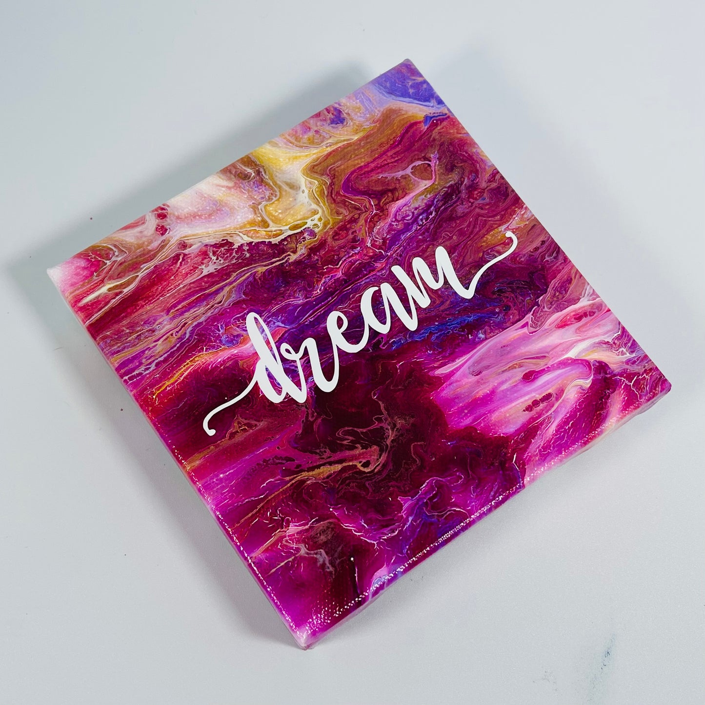 The Sky Dream Block. A colorful hand painted painting that says 'Dream'