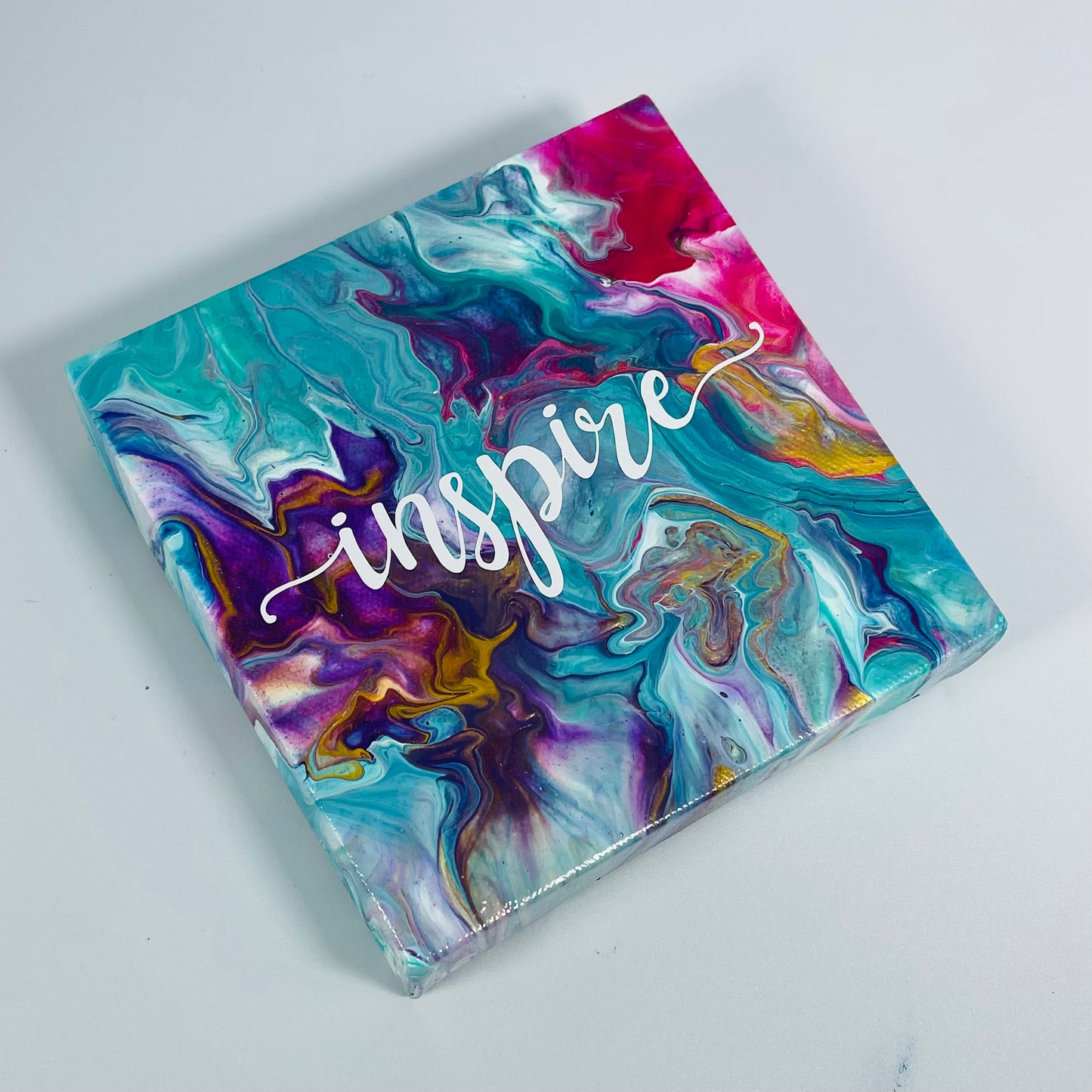 The Jasper Inspire Block. A colorful hand painted painting that says 'Inpire'