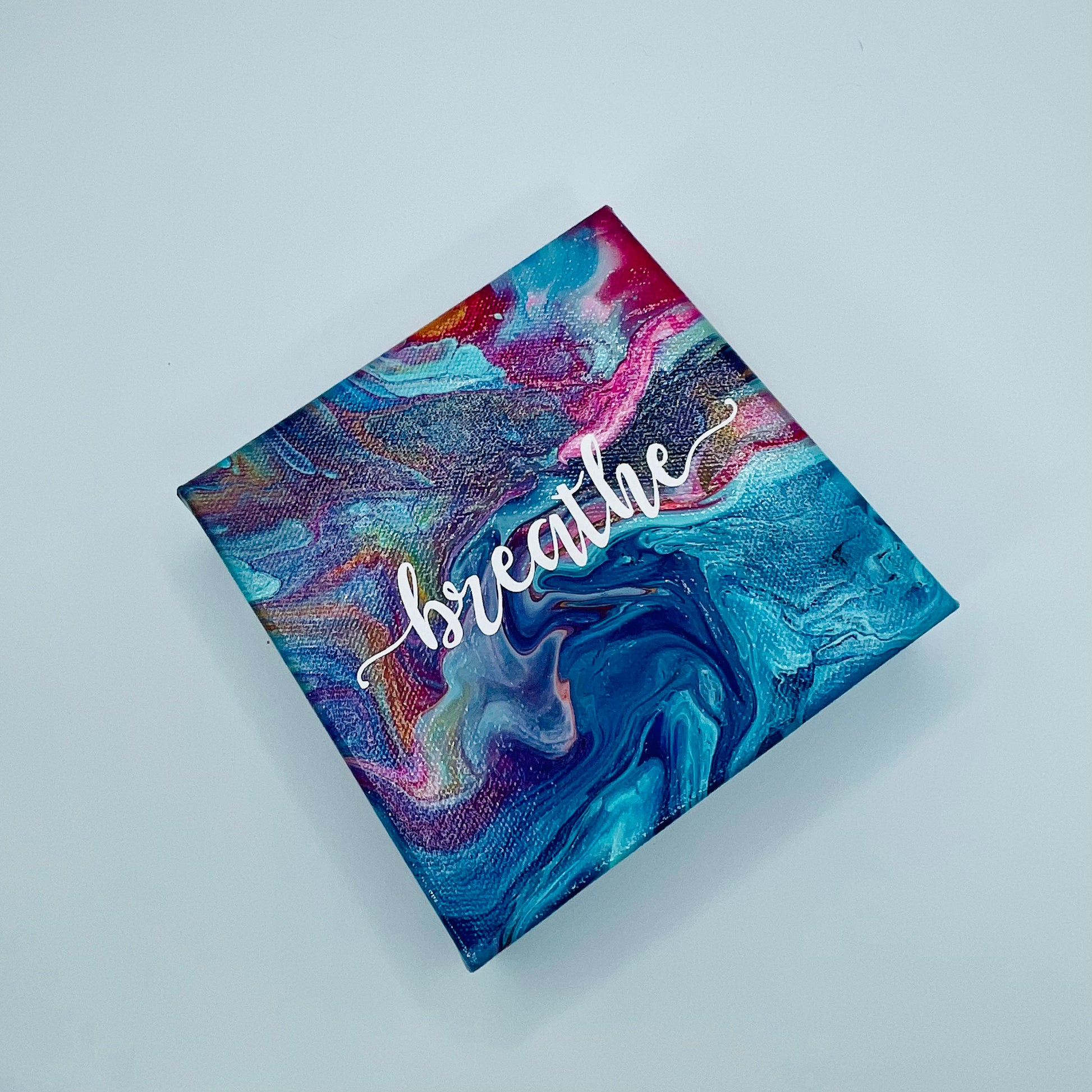 The Batsag Breathe Block. A colorful hand painted painting that says 'breathe'