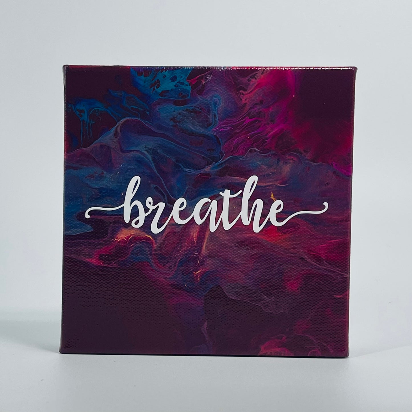 The Bjakti Breathe Block. A colorful hand painted painting that says 'breathe'