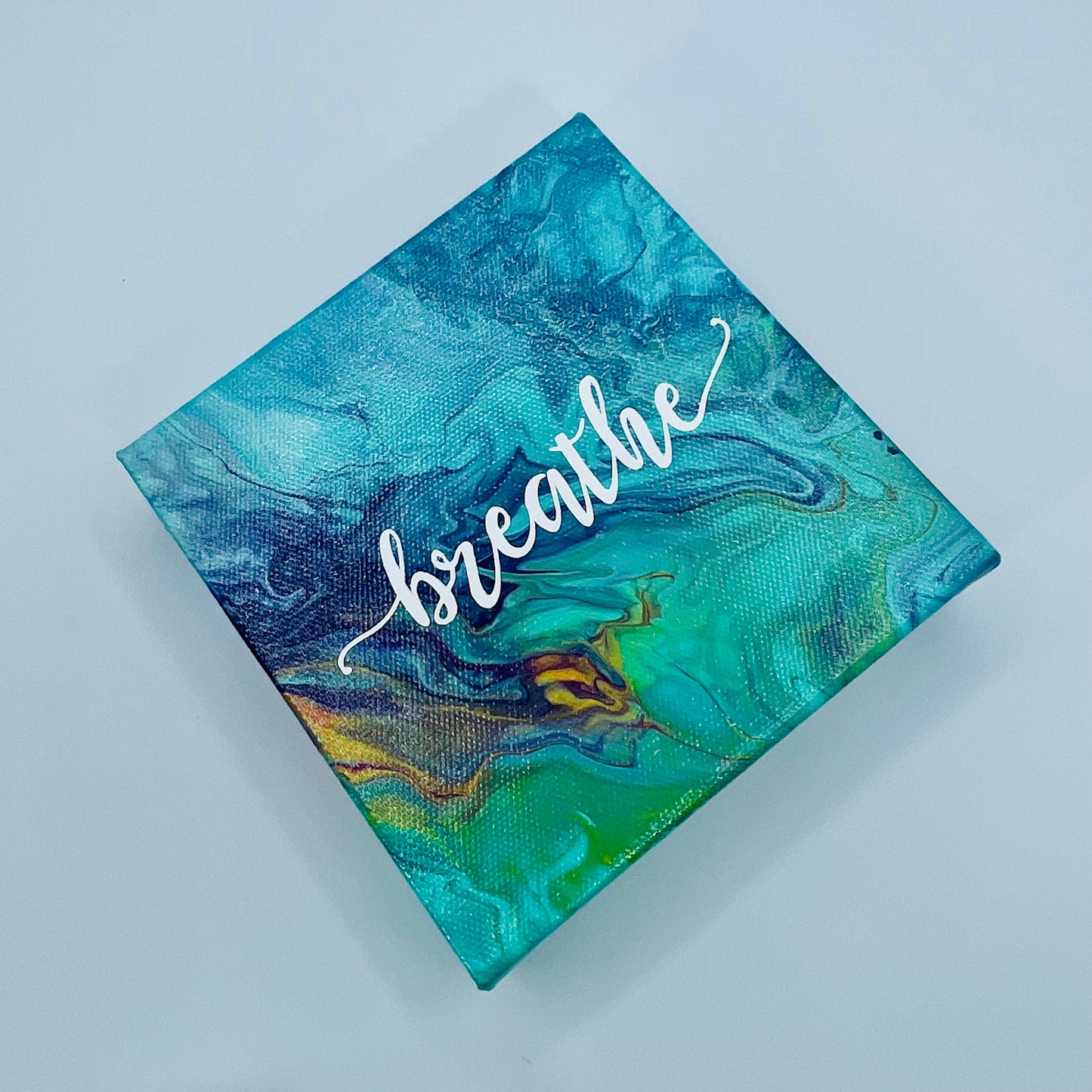 The Japa Breathe Block. A colorful hand painted painting that says 'breathe'