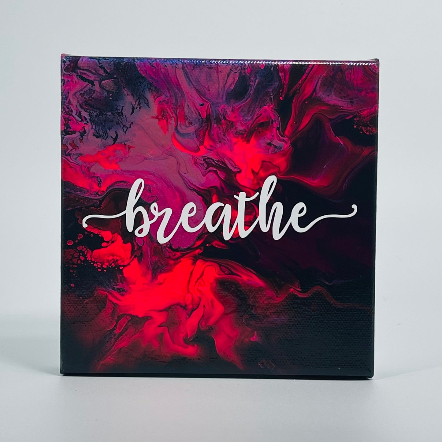 The Prema Breathe Block. A colorful hand painted painting that says 'breathe'