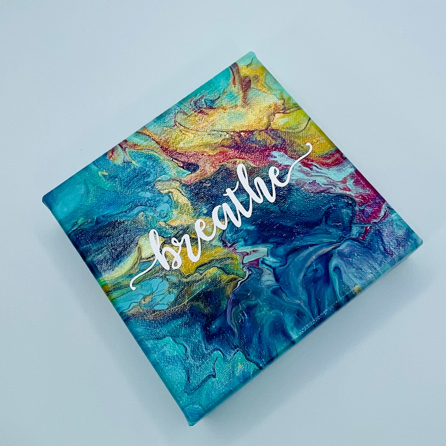 The Mudra Breathe Block. A colorful hand painted painting that says 'breathe'