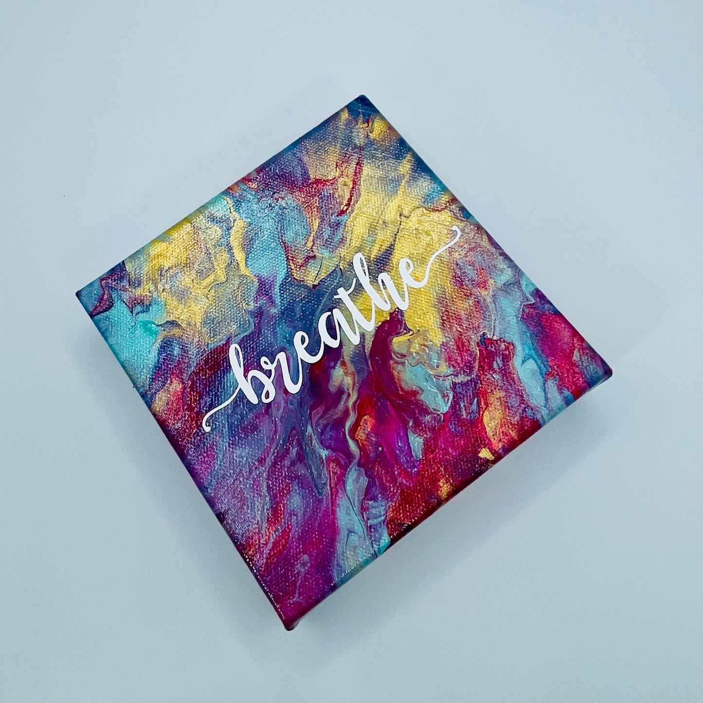 The Prana Breathe Block. A colorful hand painted painting that says 'breathe'