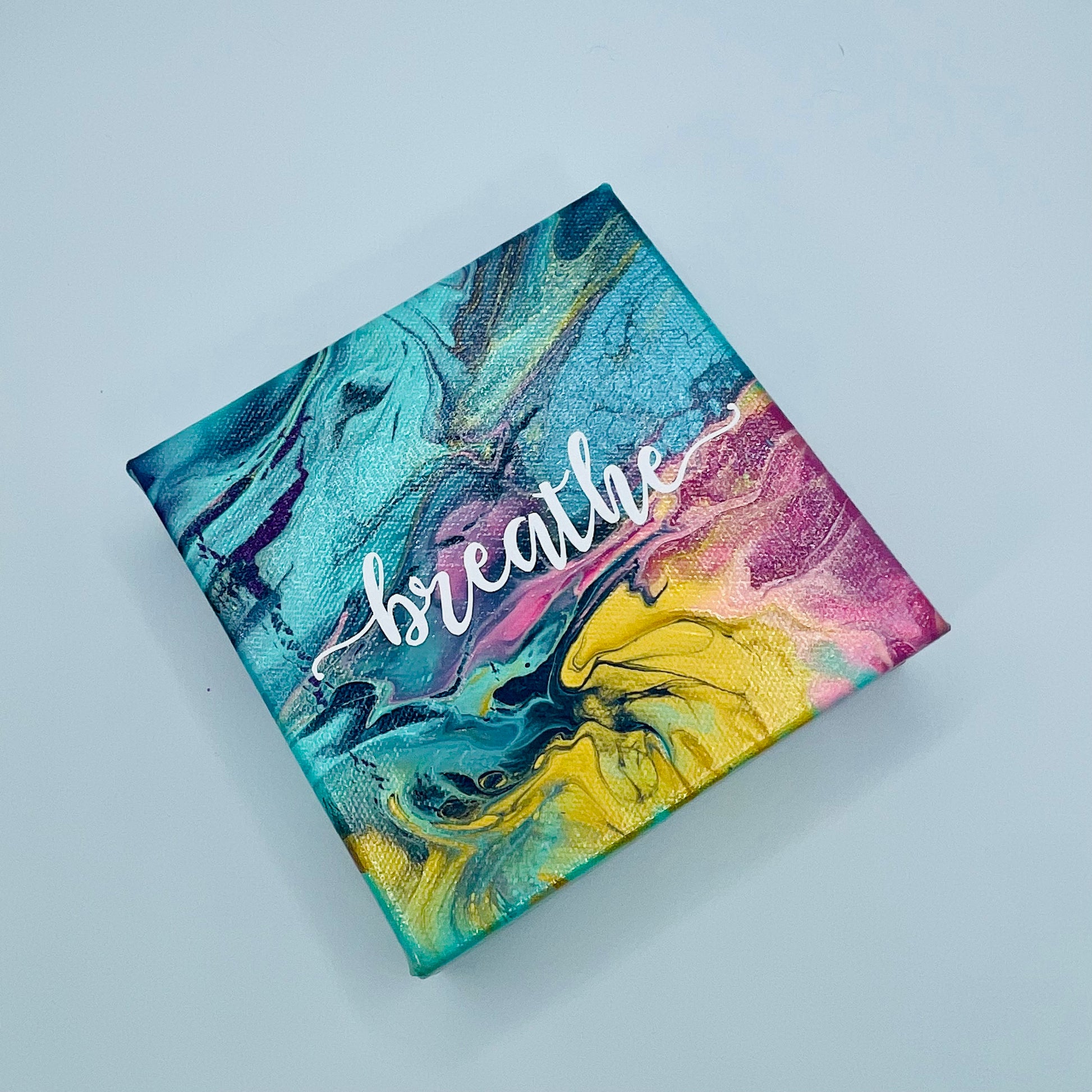 The Vidya Breathe Block. A colorful hand painted painting that says 'breathe'