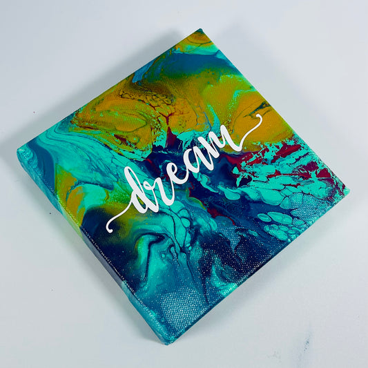 The Future Dream Block. A colorful hand painted painting that says 'Dream'