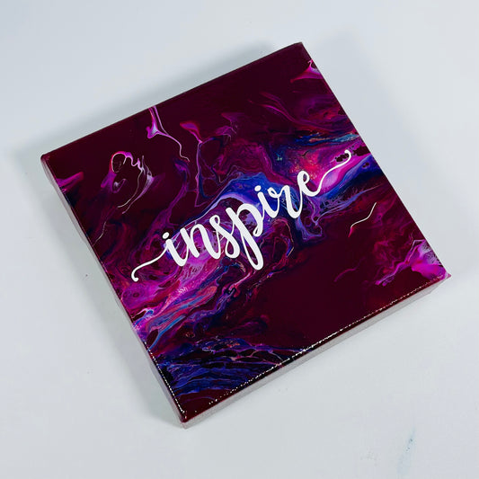 The Abra Inspire Block. A colorful hand painted painting that says 'Inpire'